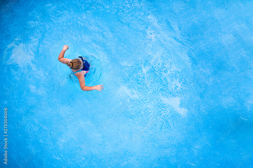 Aerial view of kid in water and summer time 