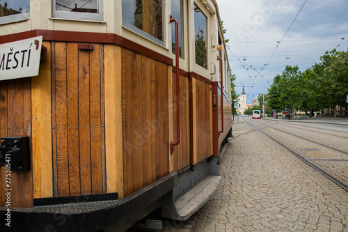 Historical tram running in Brno Czech Republic touring, old city tram lined with wood waiting in the square during a sunny day.