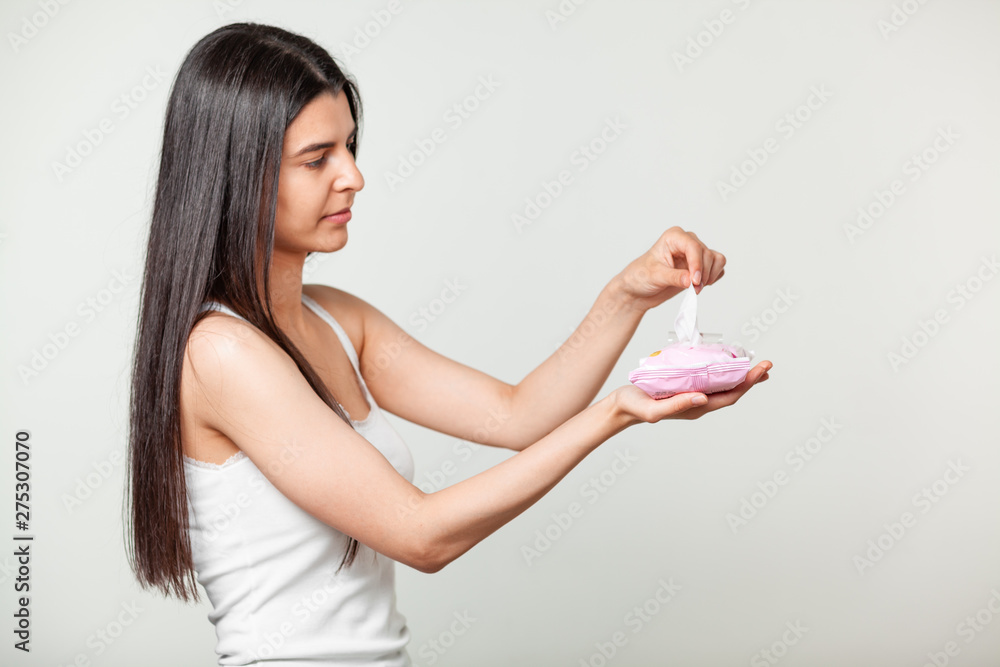 Long hair beautiful women use one Wet wipes from package in hands Long hair beautiful women use one Wet wipes from package in hands