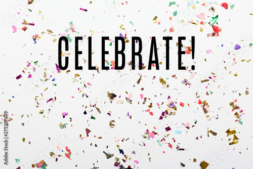 Celebrate text over glittering confetti background with copy space. Celebration message for birthday or event