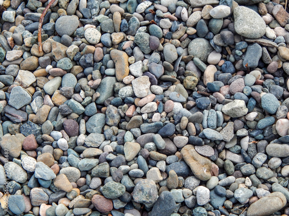 Background of Colorful Beach Rocks in Hues of Red, Gray, Green, Yellow and Blue Background of Colorful Beach Rocks in Hues of Red, Gray, Green, Yellow and Blue