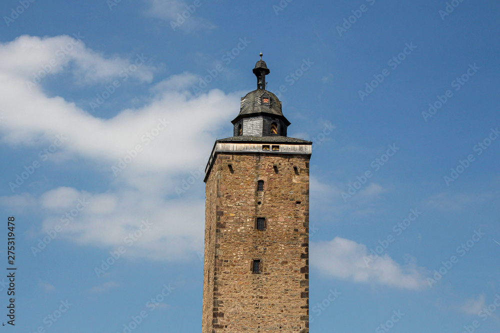 Steeple with background blue sky and little clouds in Steinau in Germany Steeple with background blue sky and little clouds in Steinau in Germany