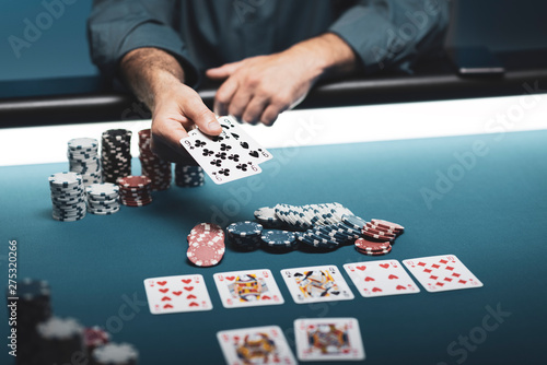 Man playing Texas Hold 'em poker at Casino photo