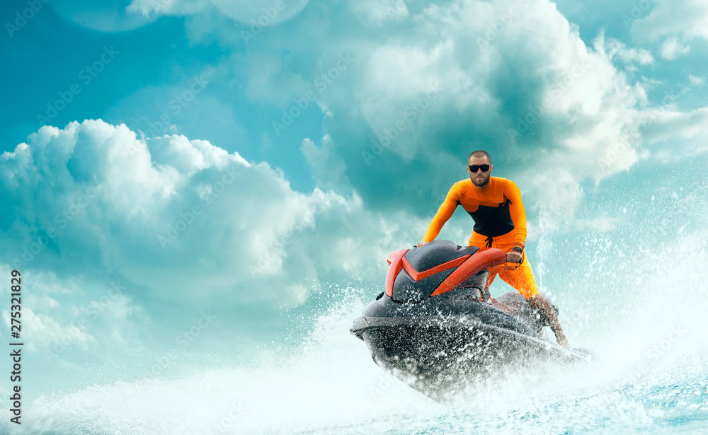 Young Man on water scooter, Tropical Ocean, Vacation Concept. Jet Ski. Sea. Young Man on water scooter, Tropical Ocean, Vacation Concept. Jet Ski. Sea.