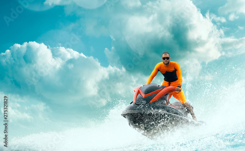 Young Man on water scooter, Tropical Ocean, Vacation Concept. Jet Ski. Sea. photo
