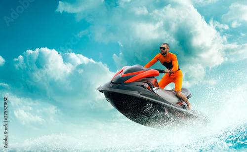 Young Man on water scooter, Tropical Ocean, Vacation Concept. Jet Ski. Sea. © VIAR PRO studio