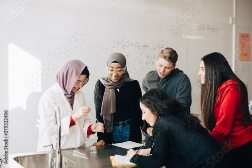 Multi-ethnic curious students learning chemistry in university