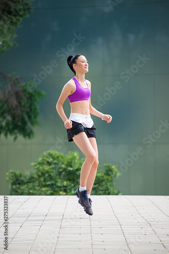 Fitness girl exercising outdoor in urban city architecture, stretching legs, doing squash, push-buttons, jumps, resting, smiling athlete body