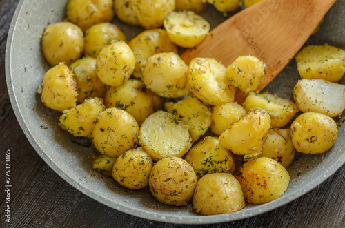 Roasted young potatoes with herbs close-up