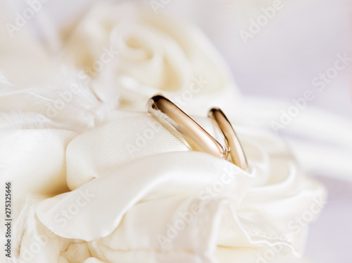 a pair of wedding gold rings on a pad