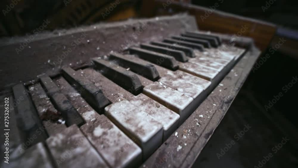 Close-up detail view of old abandoned piano destroyed by time in past auditorium in Prypiat city. View inside the destroyed building of theatre with piano in Chernobyl exclusion zone. Close-up detail view of old abandoned piano destroyed by time in past auditorium in Prypiat city. View inside the destroyed building of theatre with piano in Chernobyl exclusion zone.