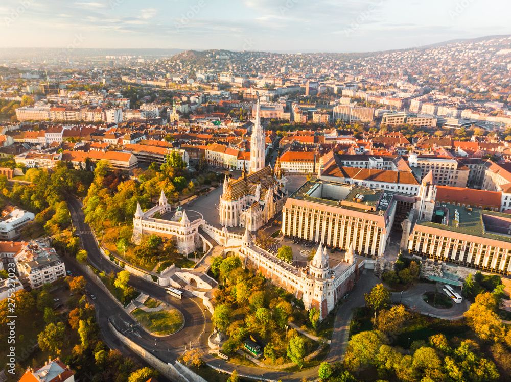 Aerial view of Fishermans Bastion and Matthias Church from above in Budapest during sunrise in autumn with dramatic sky (Budapest, Hungary, Europe)