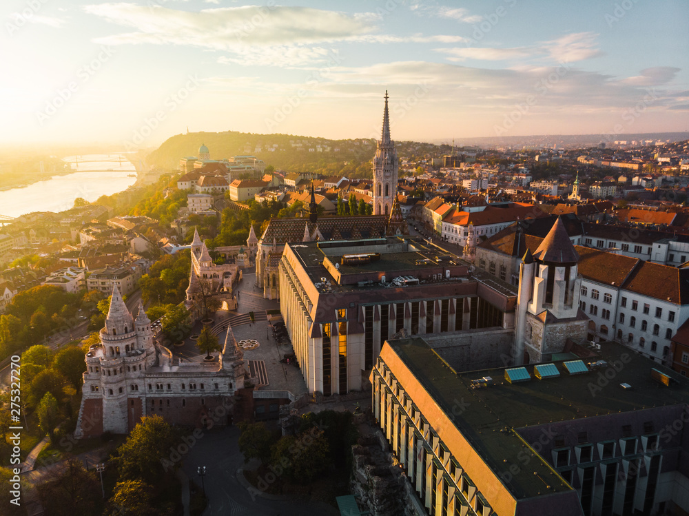 Fototapeta Aerial view of Fishermans Bastion and Matthias Church from above in Budapest during sunrise in autumn with dramatic sky (Budapest, Hungary, Europe)