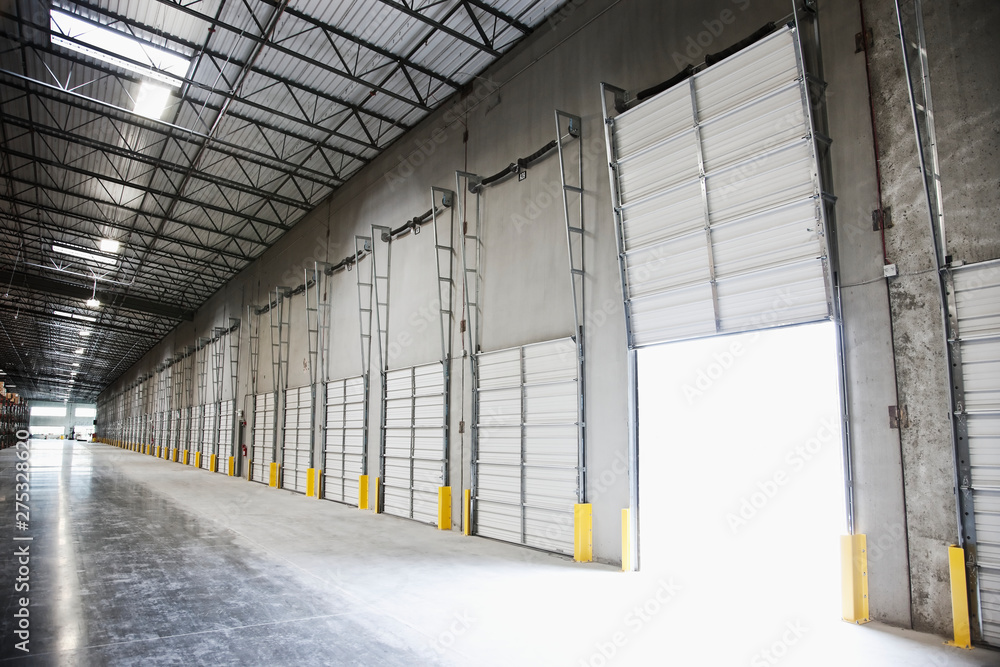 © Mint Images - Open door at loading dock in warehouse