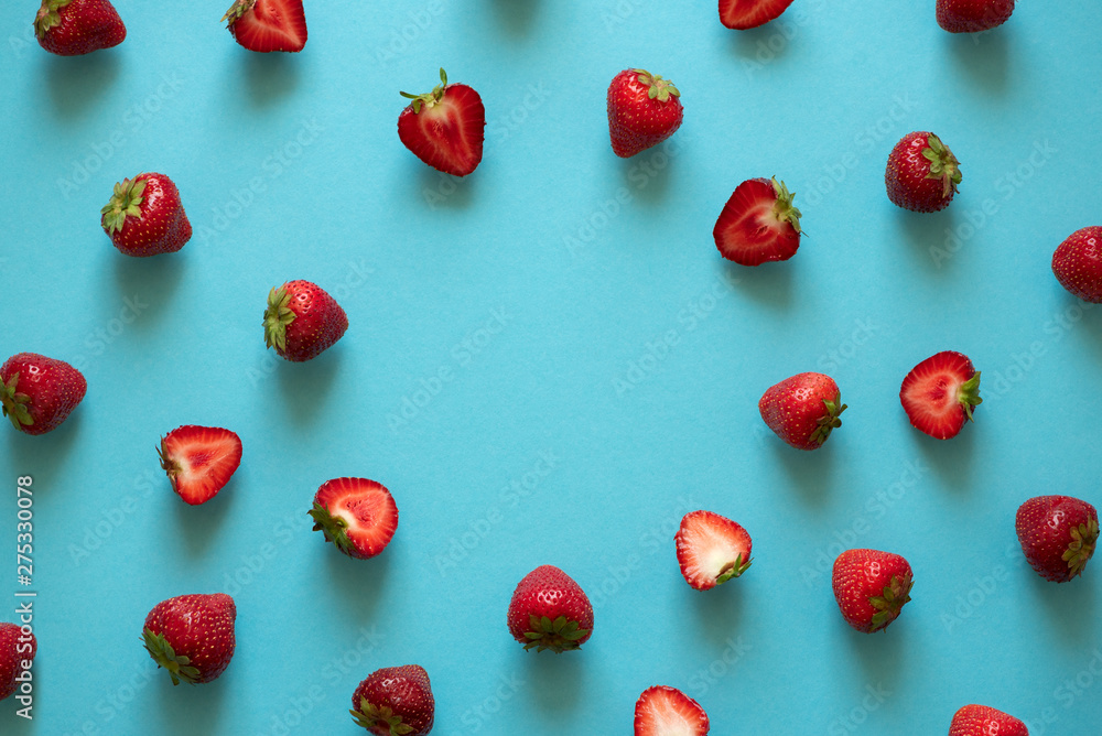 Top view on strawberry frame on blue background. Summer nature background. Berries pattern. Flat lay Top view on strawberry frame on blue background. Summer nature background. Berries pattern. Flat lay