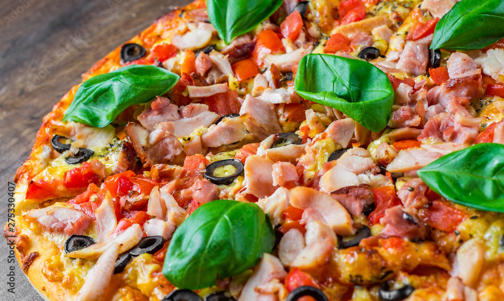 Pizza with Chicken meat, Mozzarella cheese, tomato, olive. Italian pizza on wooden background Pizza with Chicken meat, Mozzarella cheese, tomato, olive. Italian pizza on wooden background