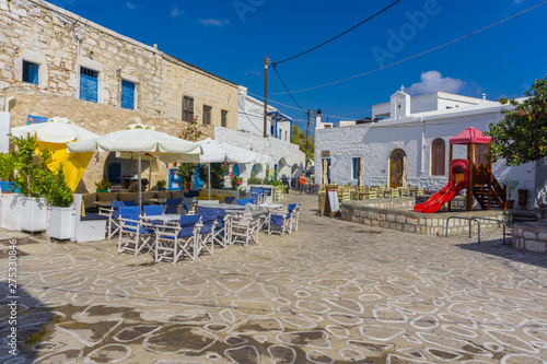 Street view of Chorio with paved alleys and traditional cycladic architecture in Kimolos island in Cyclades, Greece photo