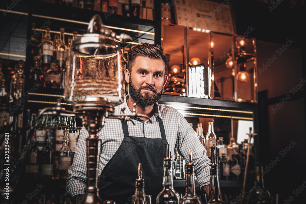 Happy cheerful barman is relaxing at his own bar while waiting for customers. Happy cheerful barman is relaxing at his own bar while waiting for customers.