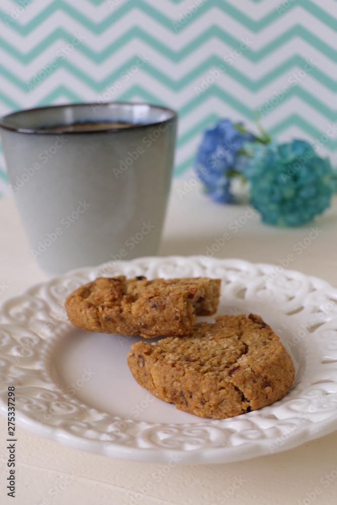 Cookies in a Plate with Caffee on a White and Green Zigzag Background Cookies in a Plate with Caffee on a White and Green Zigzag Background