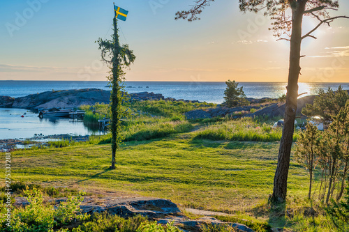 Sunrise of a classic midsommer pole at the green coast of Roslagen