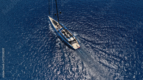 Aerial drone photo of beautiful wooden deck sail boat cruising the deep blue sea of Mykonos island, Cyclades, Greece © aerial-drone