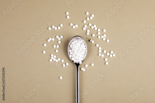 Sugar-replacing tablets with a spoon. photo