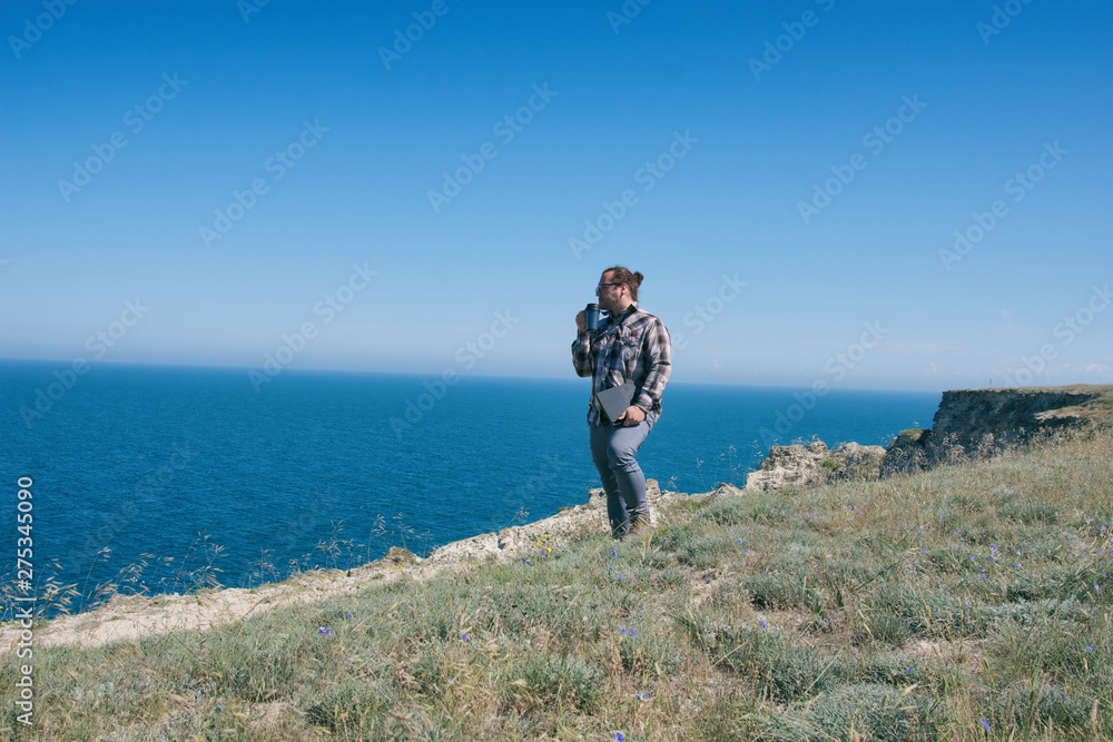 Fototapeta premium Business and vacation. A man drinks coffee.