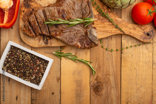 Steak with vegetables on a wooden background, restaurant and hotel business, menu, homemade recipes, culinary background, horizontal photo, banner photo