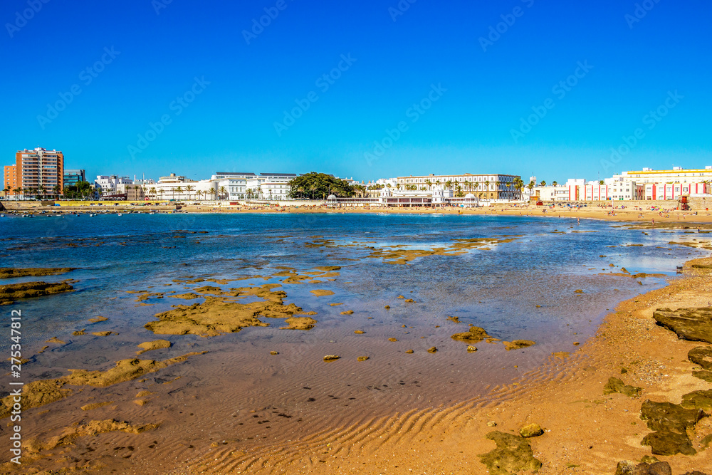 View of La Caleta Beach with El Balneario de la Palma or Spa of Our Lady of Palma and the Royal in Cadiz, Andalusia, Spain from the Castle of San Sebastian causeway