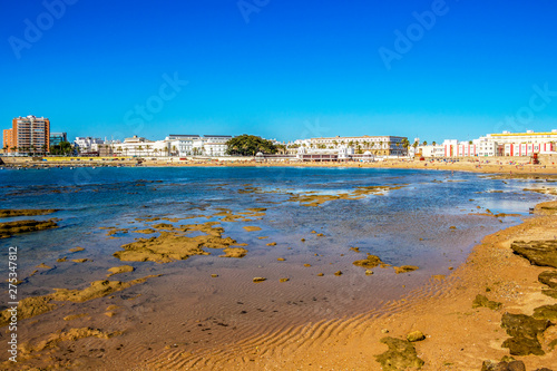View of La Caleta Beach with El Balneario de la Palma or Spa of Our Lady of Palma and the Royal in Cadiz  Andalusia  Spain from the Castle of San Sebastian causeway