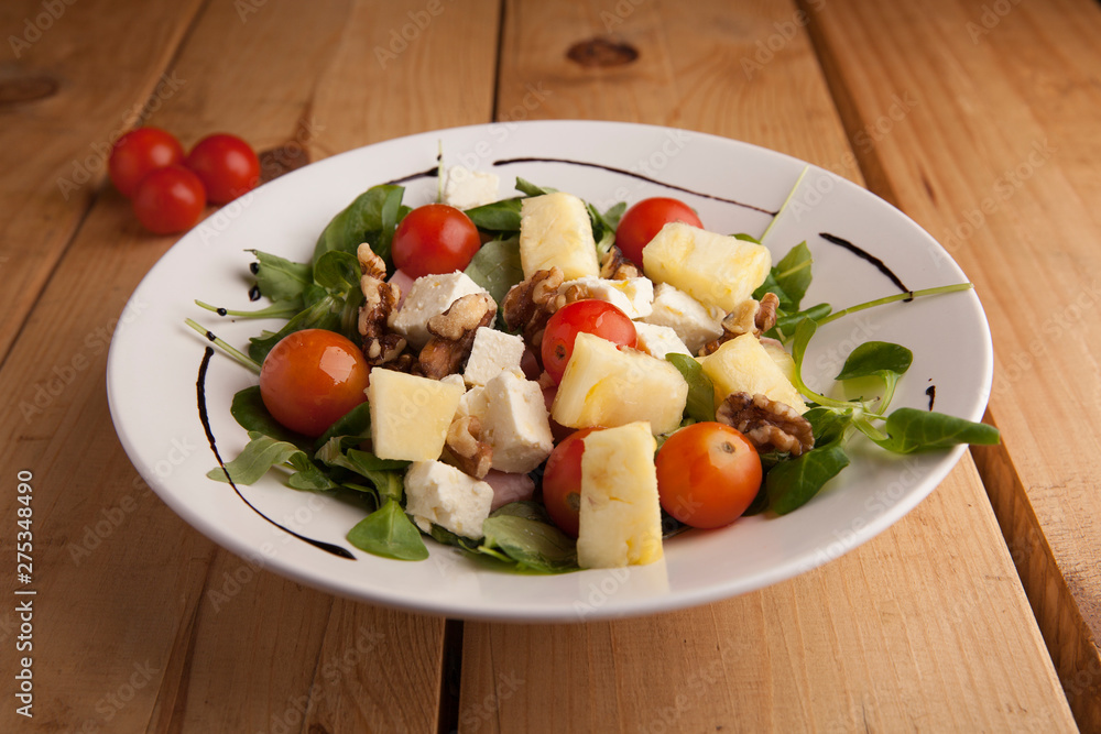 Healthy pineapple , tomato cherry , nuts and canons salad . Healthy pineapple , tomato cherry , nuts and canons salad .