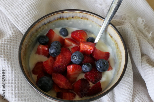 Tableau sur toile Homemade Yoghurt with Fresh Strawberries and Blueberries on a Wooden Background