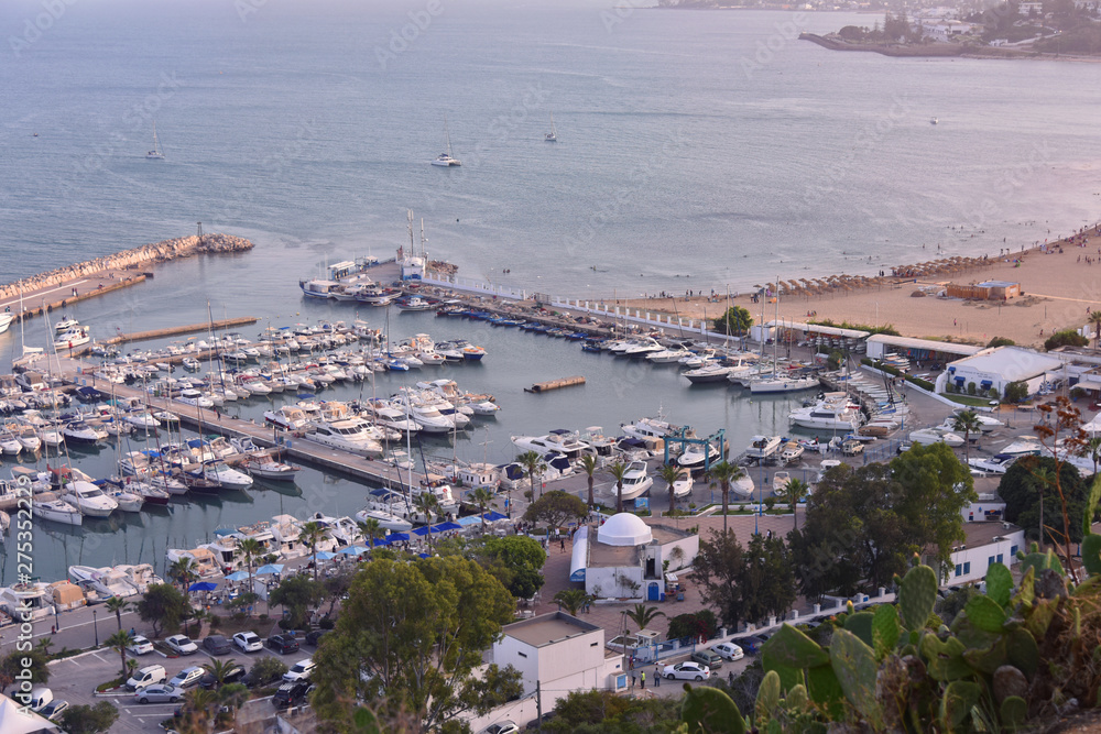 The scenic coastline of Sidi Bou Said with the large haven, full of yachts. Yachts and boats in the port of Sidi Bou Said, Tunisia