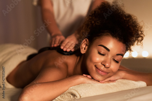 Body Treatment. Relaxed Girl Enjoying Hot Massage