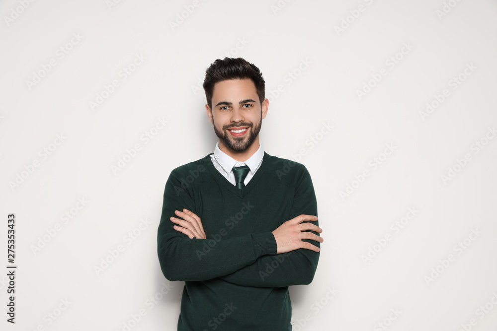 Portrait of handsome young man smiling on light background Portrait of handsome young man smiling on light background