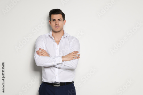 Portrait of handsome man on light background. Space for text