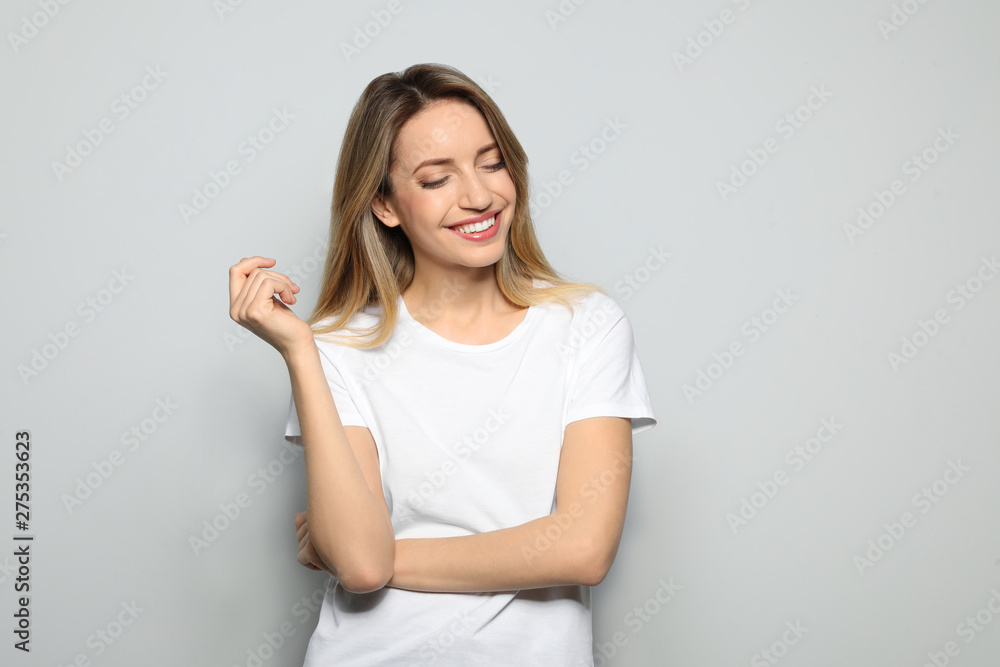 Portrait of young woman with beautiful face on grey background Portrait of young woman with beautiful face on grey background