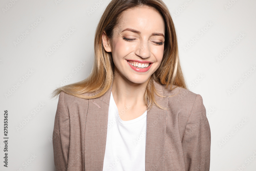 Portrait of young woman with beautiful face on light background Portrait of young woman with beautiful face on light background