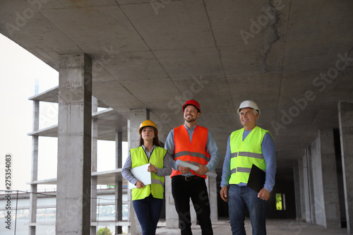 Fotografija Professional builder and foreman in safety equipment at construction site
