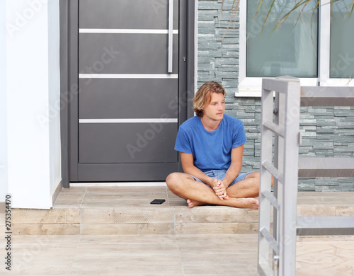 Teenager depressed sitting on stairs at home