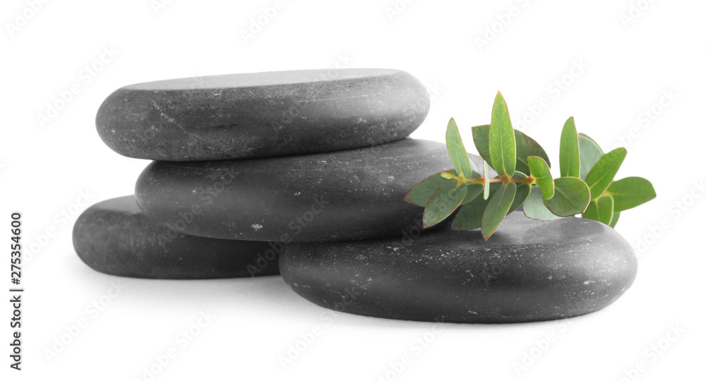 Stack of black spa stones with eucalyptus isolated on white Stack of black spa stones with eucalyptus isolated on white