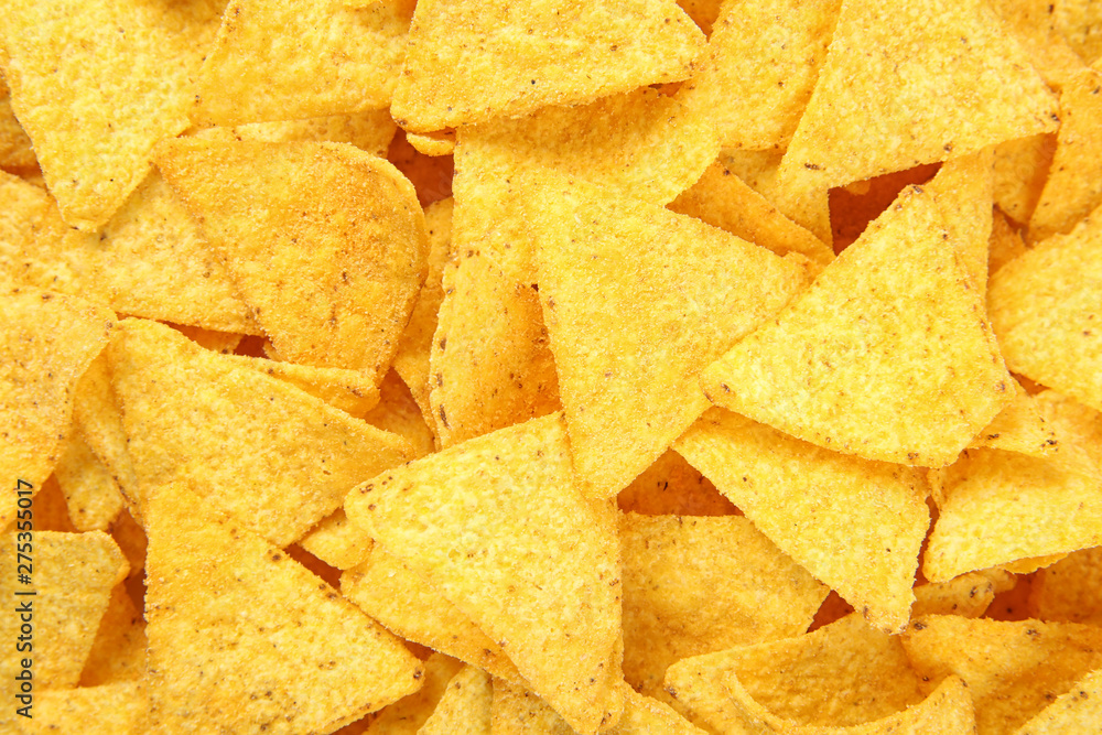 Tasty Mexican nachos chips as background, top view Tasty Mexican nachos chips as background, top view