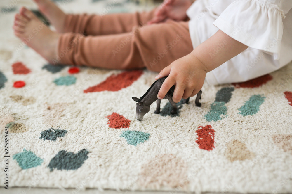 Fototapeta premium Child holds donkey's figure in his hands