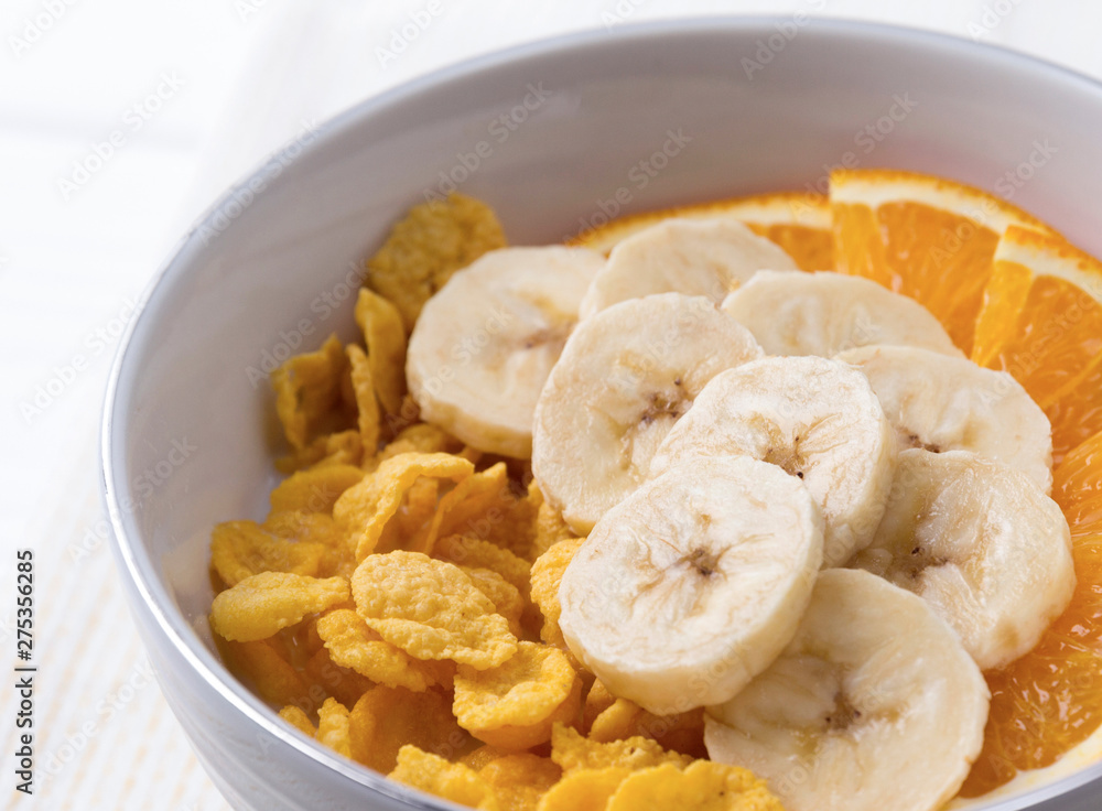 Healthy breakfast - bowl of corn flakes and fruit