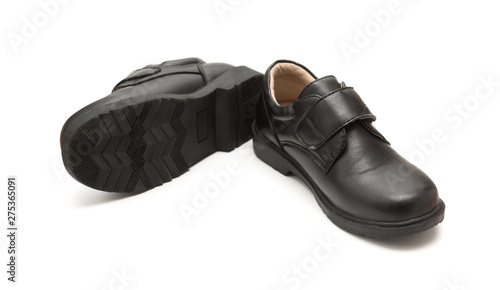 pair of brand new black leather shoe for children on white background