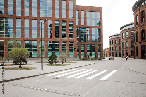 Decorative lighting pole in cityscape. Modern loft building from red brick in downtown area. Manufacture Arma in Moscow. Industrial design in city architecture. Business concept.