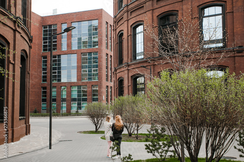 Decorative lighting pole in cityscape. Modern loft building from red brick in downtown area. Manufacture Arma in Moscow. Industrial design in city architecture. Business concept. photo