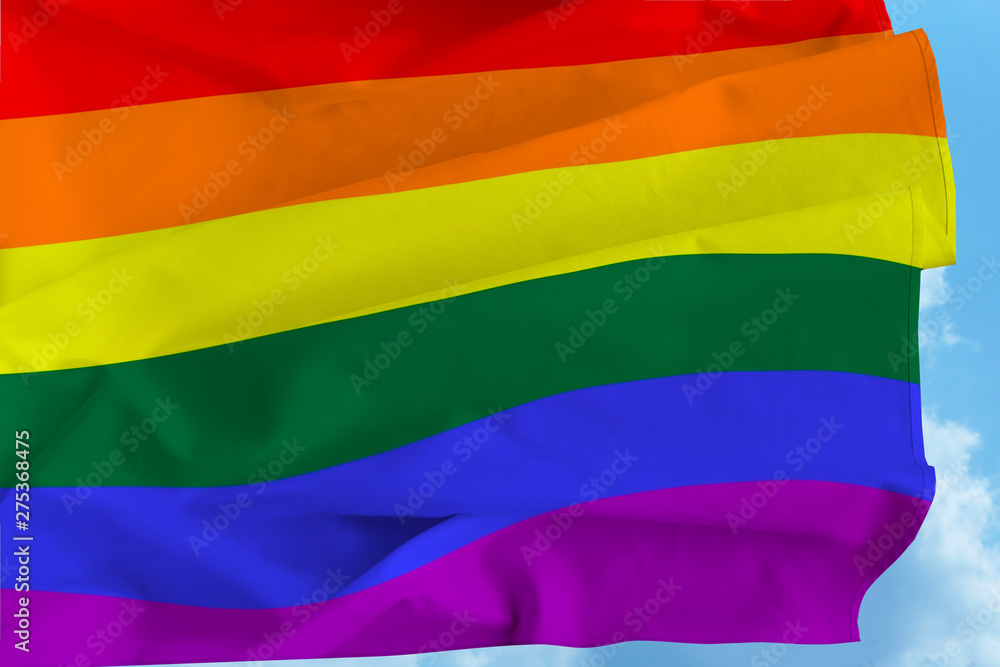 The Rainbow Pride Flag Blows in the Breeze against the Blue Sky over the San Diego LGBT Pride Parade in the Hillcrest Neighborhood The Rainbow Pride Flag Blows in the Breeze against the Blue Sky over the San Diego LGBT Pride Parade in the Hillcrest Neighborhood
