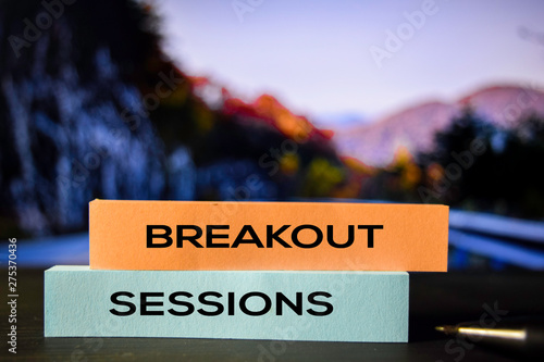 фотографія Breakout Sessions on the sticky notes with bokeh background