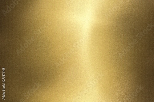 Light shining on gold wave metal wall, abstract texture background